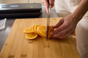 Slicing Fresh Oranges on a Beautiful Wooden Cutting Board to Enhance Your Culinary Skills