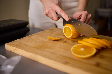 Slicing Fresh Oranges on a Beautiful Wooden Cutting Board to Enhance Your Culinary Skills