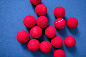 Training, floor and tennis balls for game or sport, practice and workout for skill development for tournament or match. Blue court or pitch, red equipment and ground for athletic activity and fitness
