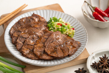 Taiwanese braised beef shank slices in a plate on white table background.