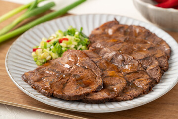 Taiwanese braised beef shank slices in a plate on white table background.