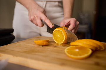 Slicing Fresh Oranges on a Beautiful Wooden Cutting Board to Enhance Your Culinary Skills