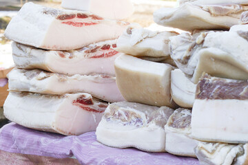 Pieces of fresh lard with layers of meat. Delicious homemade lard for sale at the farmers market.