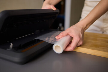 Hands Skillfully Preparing Vacuum Sealing for Food Preservation and Storage Purposes