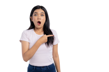 Surprised young Asian woman pointing at copy space with open mouth, shocked expression, isolated on transparent background