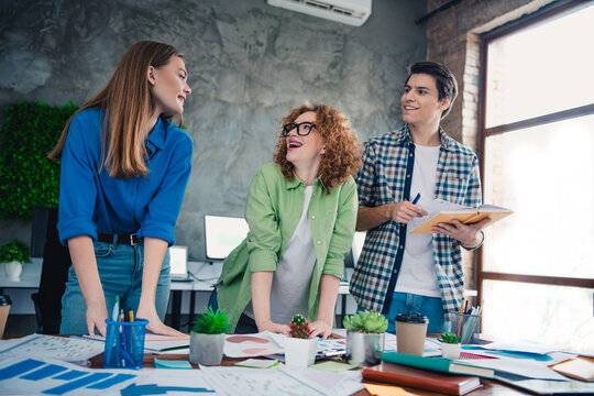 Young professionals collaborating in a friendly office space, brainstorming innovative ideas together during a creative business meeting