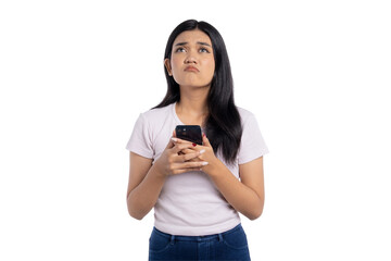Young Asian woman looking frustrated while holding her smartphone, isolated on transparent...
