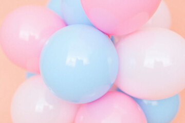 bunch of pink and blue balloons on a pink background