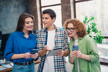 Young diverse group of coworkers collaborating in a modern office setting supporting teamwork