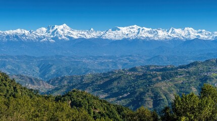 Obraz premium Majestic snow covered mountain range over rolling green hills