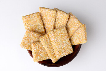 Indian Sweet called Gajak made with Sesame and jaggery isolated on white background  