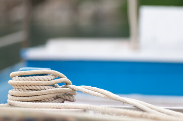 Coiled rope on boat deck with blurred background