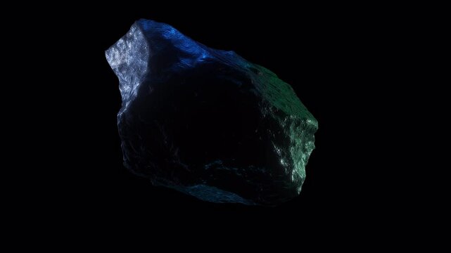 Close in on a moodily lit space rock spinning on an endless loop with alpha for easy overlay.