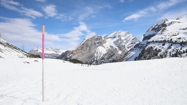 Snow depth marker on winter mountain landscape, wide establisher