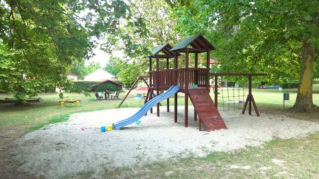 Push in shot of slide and playground equipment at a waterpark during the day, outdoor