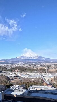 Mount Fuji time lapse daytime clouds forming and traffic driving by on highway portrait