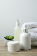 Stack of bath towels with cosmetics on the table