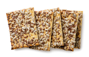 Crackers with seeds scattered on a white background. Top view