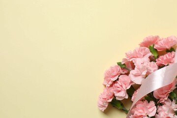Beautiful bouquet of pink carnations on a colored background