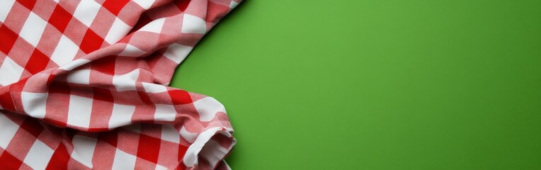 Fototapeta premium Red Checkered Picnic Table with Blurry Green Background