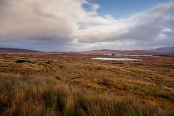 Golden heather blankets the Scottish Highlands, where misty peaks rise above deep glens and serene lochs. Autumn’s glow paints a landscape of wild, untamed beauty.