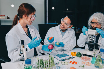 Team Asian scientists in a lab conducting food research using a microscope and lab equipment,...