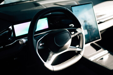 Naklejka premium steering wheel and control buttons in an expensive new car