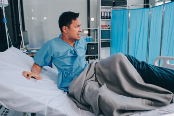 Lonely man silhouette sitting on the bed feeling depressed and stressed in the dark bedroom, Depression and anxiety disorder concept