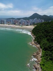 Vibrant coastal city with lush greenery and beaches.