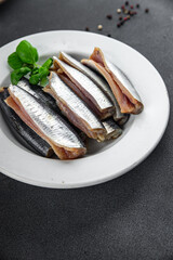 Sardines fish salted gourmet food background on the table rustic food top view copy space