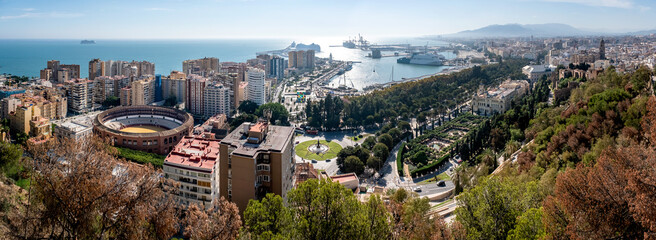 Panorama cityscape aerial view of Malaga, Spain. In the center is Plaza de Toros de Ronda bullring in Malaga, Spain.
