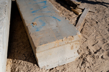 Large size baton cement blocks in construction yard. buILDING MATERIALS IN SAND AT CONSTRUCTION YARD FOR BUILDING LARGE SCALE SKYSCRAPERS