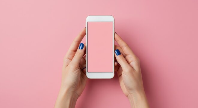 Hands holding a white phone against pink.
