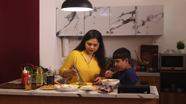 Woman serving food to her son