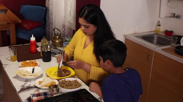 Mother serving breakfast for his son