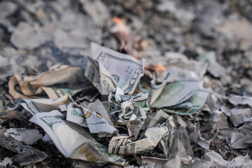 Burning US Dollar Bills on Ashes Representing Financial Loss and Waste