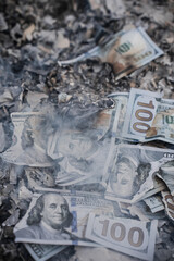 Burning US Dollar Bills on Ashes Representing Financial Loss and Waste