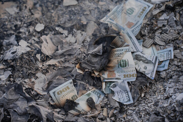 Burning US Dollar Bills on Ashes Representing Financial Loss and Waste