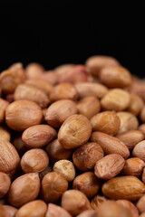 Peanut background, lots of raw peeled brown peanuts close-up.