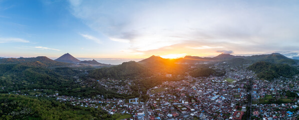 Stunning aerial panoramic view of Bajawa, Indonesia, at sunset. The golden light highlights the...