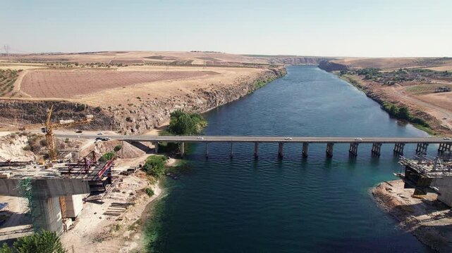 Aerial view of bridge under construction. Highway bridge and bridge being constructed aerial view. Euphrates river, Sanliurfa province, Turkey