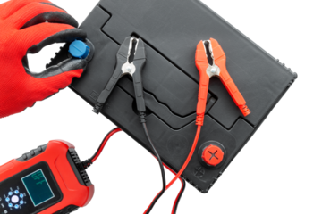Positive terminal and negative terminal of booster cables with car battery charging on AGM battery. Concept of battery or car recovery with error. Top view, studio set, isolated background.