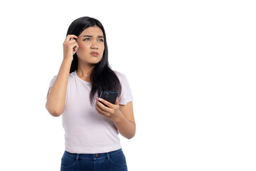 Confused young Asian woman holding smartphone and scratching head with puzzled expression, looking up, isolated on transparent background