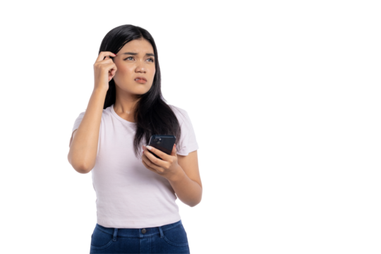 Confused young Asian woman holding smartphone and scratching head with puzzled expression, looking up, isolated on transparent background - Powered by Adobe