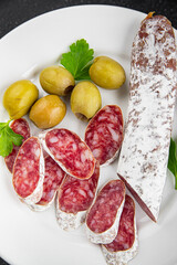 Fuet sausage meat Spanish delicacy gourmet food background on the table rustic food top view copy...