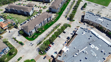 Commercial strip mall, shopping center, restaurants complex near new construction apartment building in mixed use development area, northwestern Harris County, Greater Houston, rooftop HVAC units