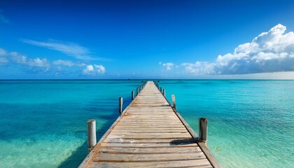 Obraz premium wooden pier on a tropical beach with calm blue caribbean sea water on a sunny day dominican republic