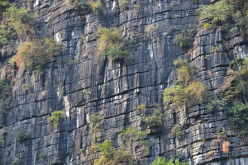 Very clear linear parallel faults in the rock face of a limestone mountain