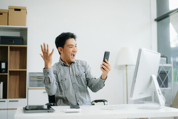 Confident business expert attractive smiling young man typing laptop and holding digital tablet on...