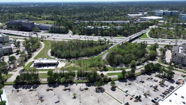 Business park ample parking space along busy Texas State Highway 249 Tomball Parkway with overpass, lush green fast-growing mixed-use, building, hotel, Northwest Harris County, Houston, flyover